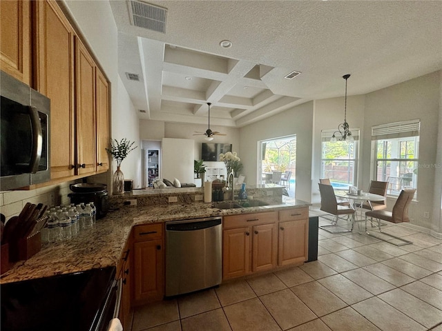 kitchen with a peninsula, a sink, visible vents, coffered ceiling, and appliances with stainless steel finishes