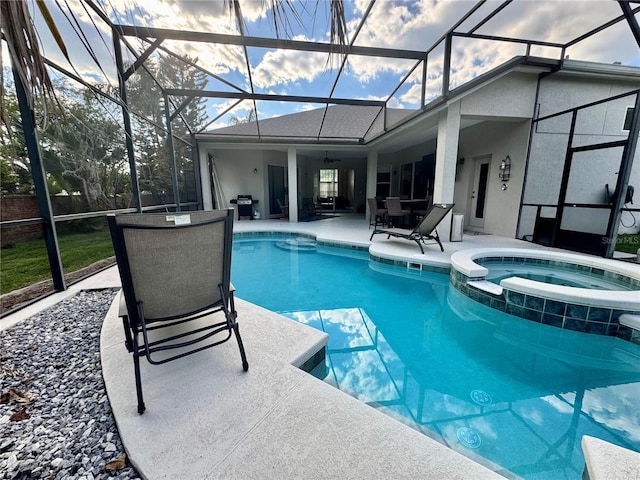 view of swimming pool featuring a lanai, a pool with connected hot tub, a patio area, and a ceiling fan