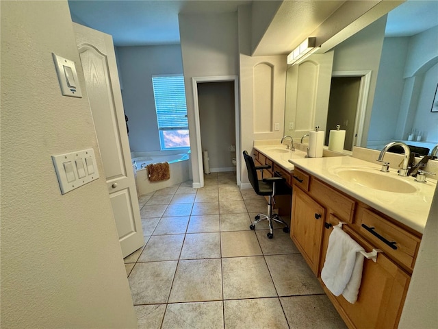 full bathroom featuring vanity, toilet, tile patterned flooring, and a garden tub