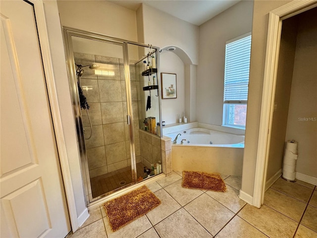 bathroom with a bath, tile patterned flooring, and a stall shower