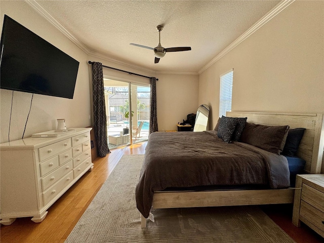 bedroom with a textured ceiling, ceiling fan, access to outside, light wood finished floors, and ornamental molding