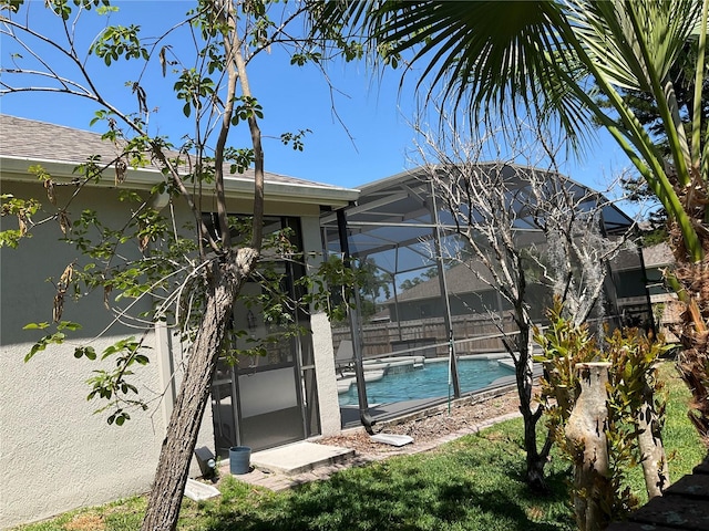 exterior space featuring glass enclosure and fence