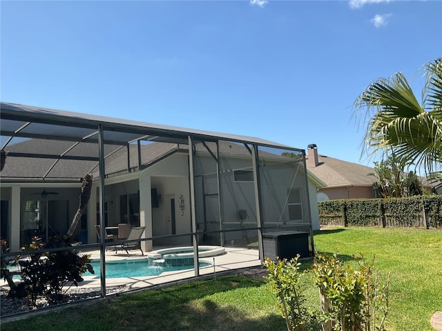 rear view of property featuring stucco siding, a yard, a patio area, and ceiling fan