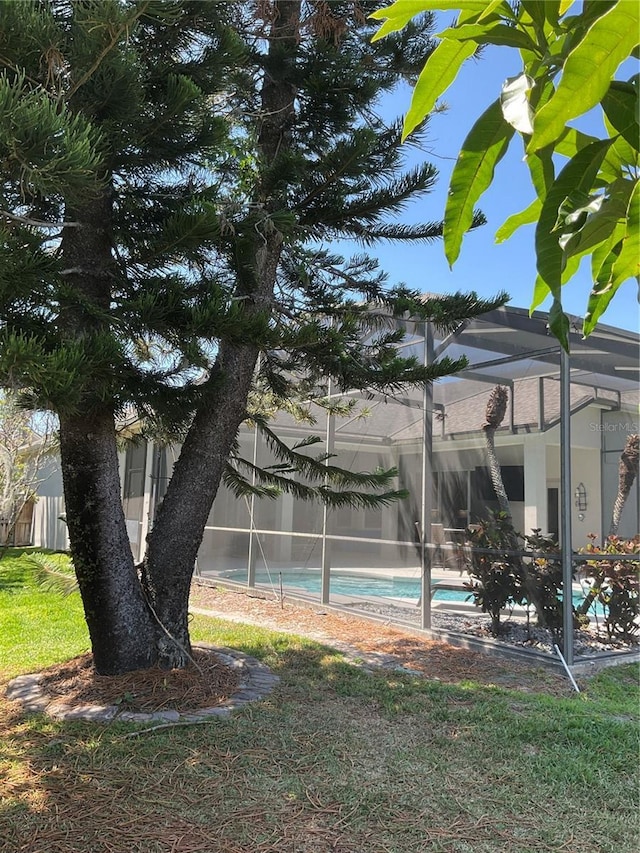 view of yard featuring a fenced in pool, a lanai, and fence