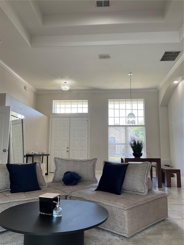 tiled living room featuring visible vents, a wealth of natural light, and crown molding
