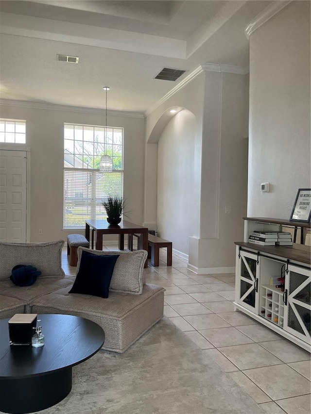 living room with arched walkways, visible vents, ornamental molding, and light tile patterned floors