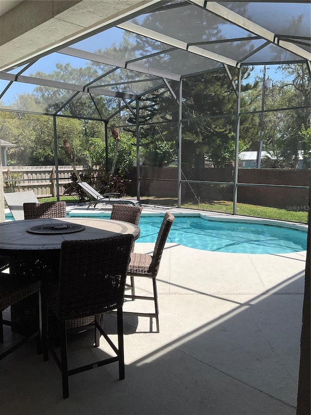 view of pool featuring a fenced in pool, a patio area, a fenced backyard, and a lanai