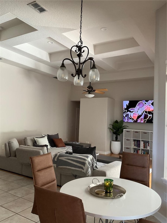 dining room featuring ceiling fan with notable chandelier, light tile patterned floors, coffered ceiling, beam ceiling, and visible vents
