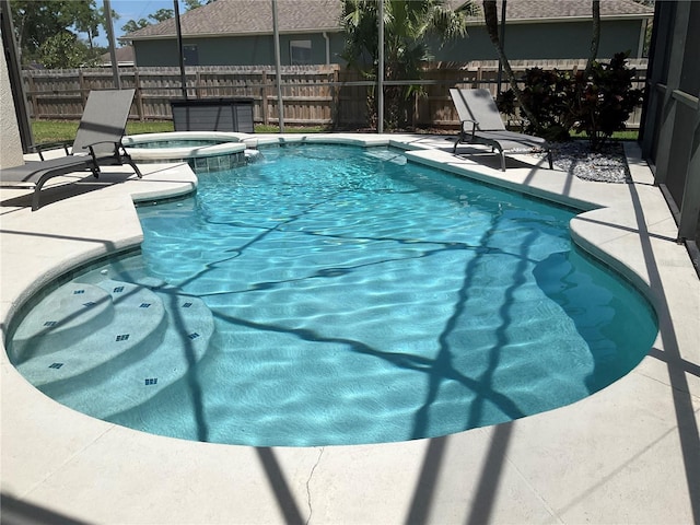 view of pool with a fenced in pool, a patio area, an in ground hot tub, and fence