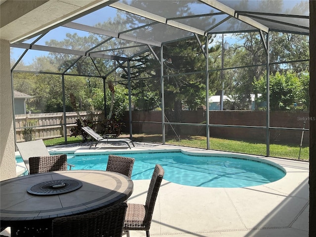 view of pool featuring a fenced backyard, a lanai, and a patio