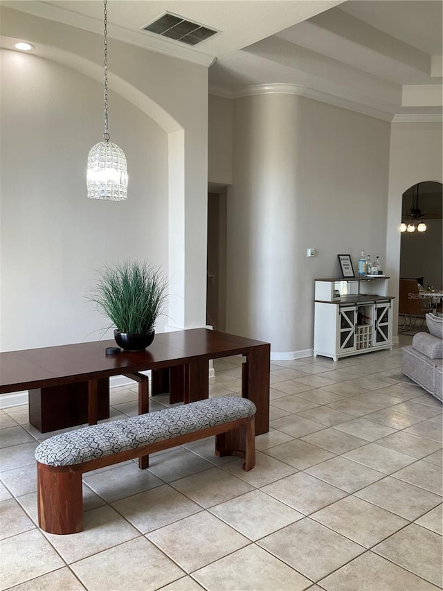 dining area with a chandelier, arched walkways, visible vents, and ornamental molding