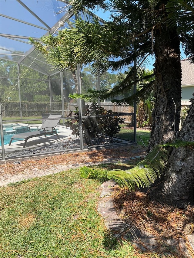 view of yard with a lanai, a patio, and an outdoor pool