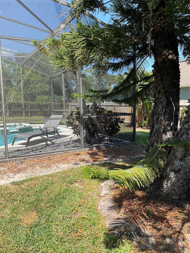view of yard featuring a lanai, an outdoor pool, and a patio area