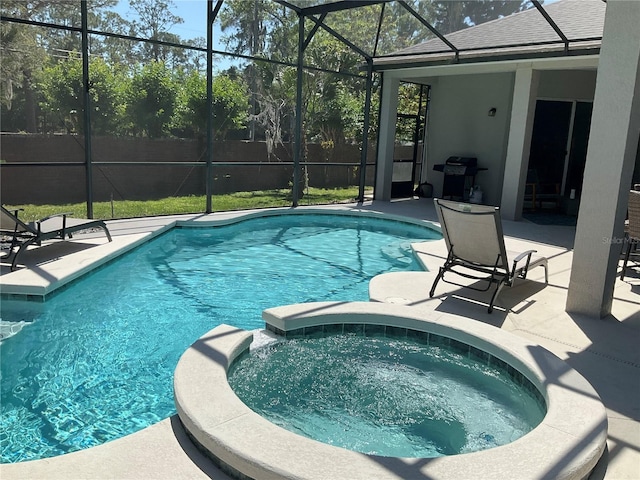 view of pool featuring a lanai, a patio, and a pool with connected hot tub