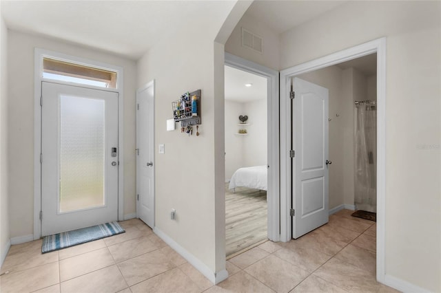 9005 Tuscan Cypress St, Kissimmee, FL 34747 - foyer entrance featuring arched walkways and light tile patterned flooring