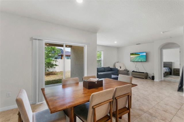 9005 Tuscan Cypress St, Kissimmee, FL 34747 - dining room featuring arched walkways, light tile patterned flooring, and recessed lighting
