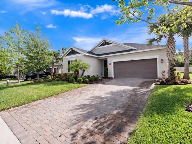 1151 Lakeside Estates Dr, Apopka, FL 32703 - ranch-style home with decorative driveway, a front yard, stucco siding, and an attached garage
