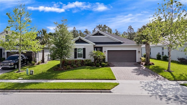 1151 Lakeside Estates Dr, Apopka, FL 32703 - ranch-style house with stucco siding, a garage, a front yard, and decorative driveway