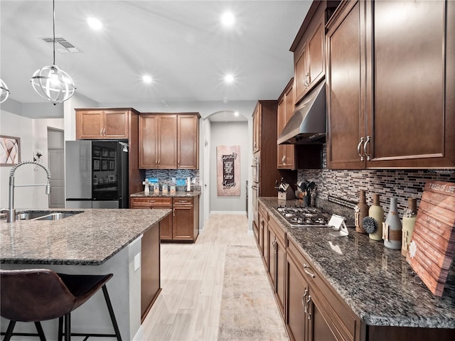 1151 Lakeside Estates Dr, Apopka, FL 32703 - kitchen featuring smart refrigerator, under cabinet range hood, a sink, and dark stone countertops