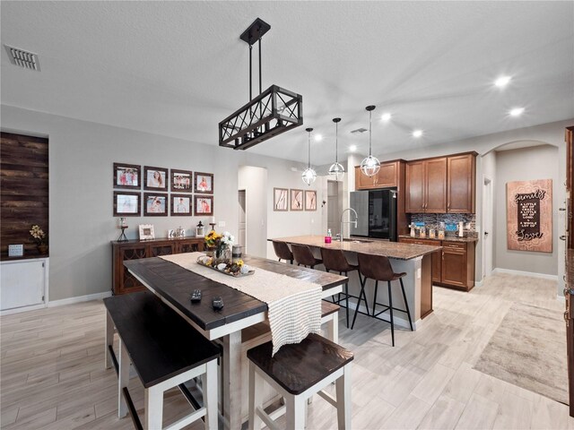 1151 Lakeside Estates Dr, Apopka, FL 32703 - dining room featuring arched walkways, visible vents, recessed lighting, and light wood finished floors