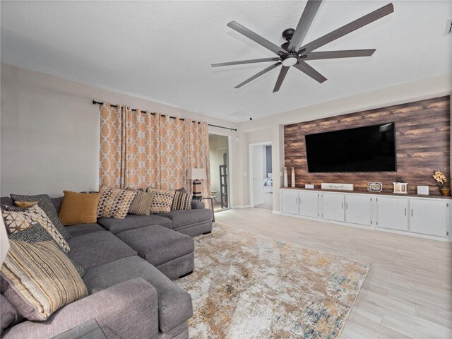1151 Lakeside Estates Dr, Apopka, FL 32703 - living area featuring light wood-type flooring, an accent wall, and ceiling fan