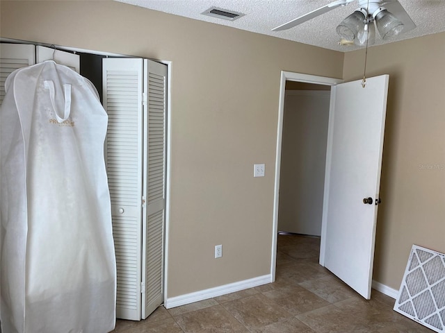 1210 Etchfield Cir, Brandon, FL 33511 - unfurnished bedroom featuring a closet, a textured ceiling, and ceiling fan
