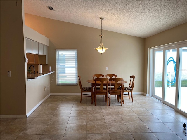 1210 Etchfield Cir, Brandon, FL 33511 - dining room with healthy amount of natural light, a textured ceiling, lofted ceiling, and light tile patterned floors