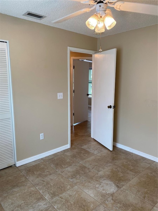 1210 Etchfield Cir, Brandon, FL 33511 - unfurnished bedroom with a textured ceiling, a closet, and ceiling fan