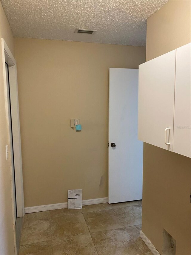 1210 Etchfield Cir, Brandon, FL 33511 - laundry area featuring a textured ceiling and baseboards