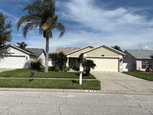 1210 Etchfield Cir, Brandon, FL 33511 - single story home featuring an attached garage, concrete driveway, a front lawn, and stucco siding