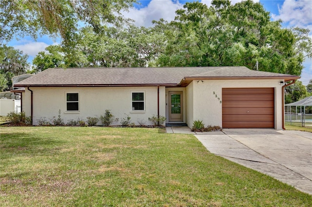 ranch-style house featuring a garage, a front yard, stucco siding, a shingled roof, and concrete driveway