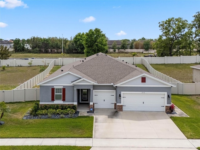 view of front of home with a fenced backyard, a front yard, driveway, and a garage