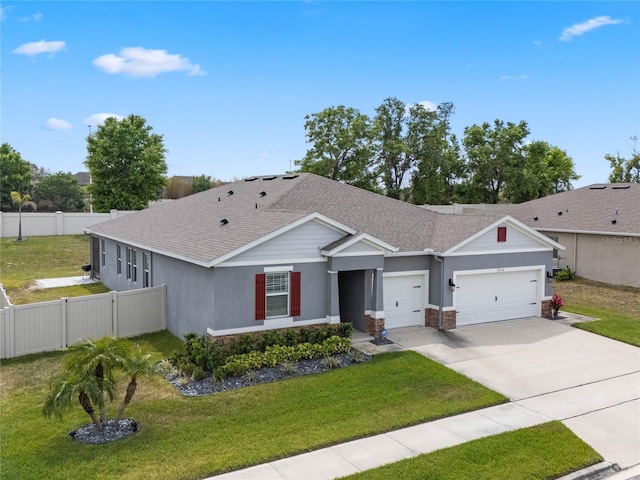 ranch-style house with a front lawn, fence, driveway, and a garage