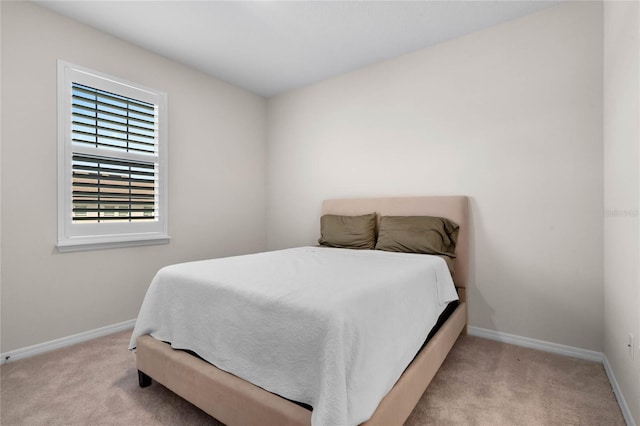 bedroom featuring carpet and baseboards