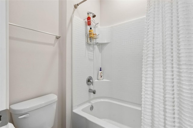 full bath featuring toilet and shower / bath combo with shower curtain