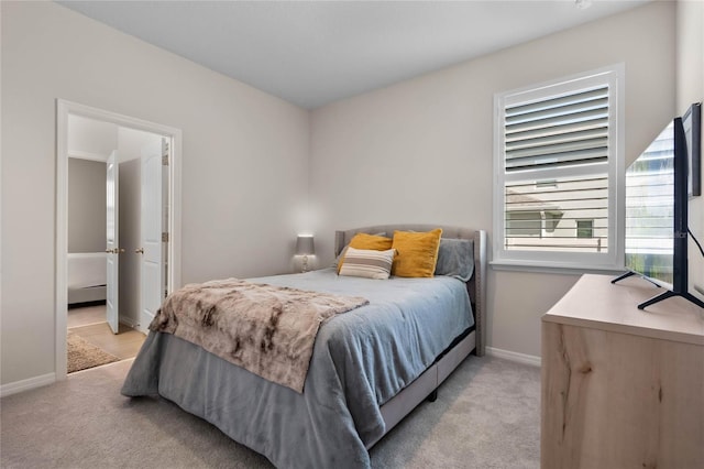 bedroom featuring baseboards and light colored carpet