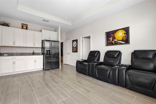 home theater featuring visible vents and a raised ceiling