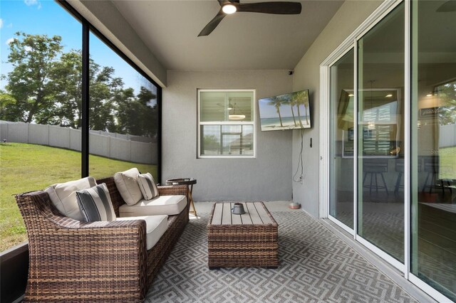 sunroom / solarium featuring an outdoor living space and a ceiling fan