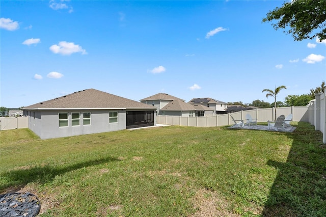 view of yard with a fenced backyard and a sunroom