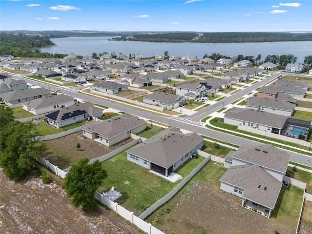 birds eye view of property with a water view and a residential view