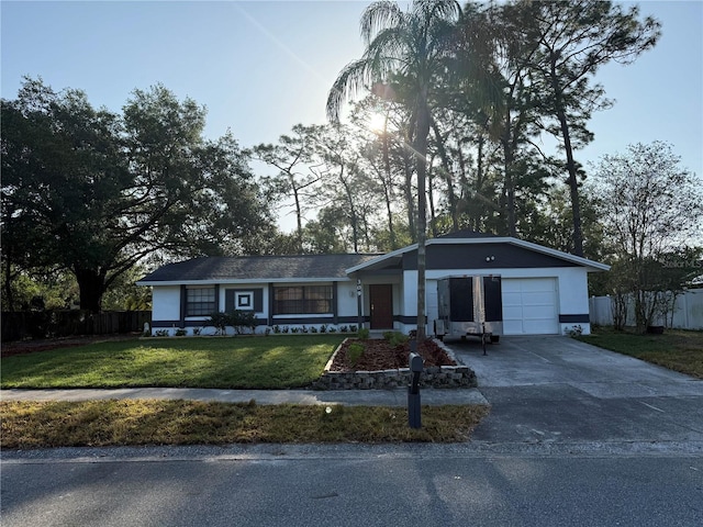 ranch-style house featuring fence, driveway, a front yard, and a garage