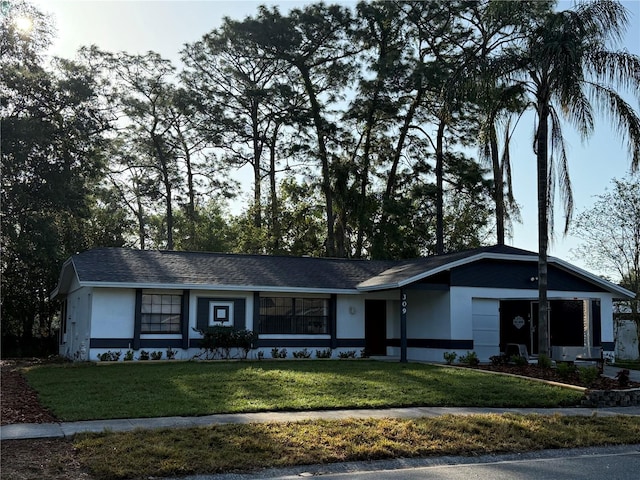 ranch-style home featuring stucco siding and a front lawn