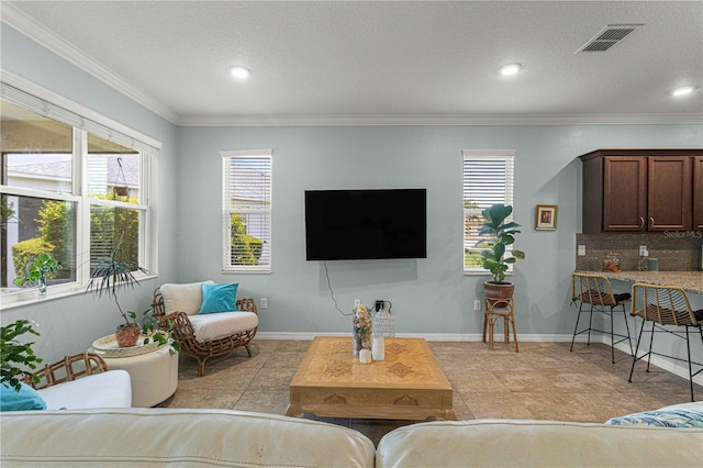 living room featuring ornamental molding, visible vents, and recessed lighting