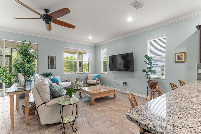 living area featuring visible vents, baseboards, a ceiling fan, crown molding, and recessed lighting