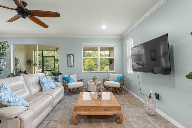living room featuring crown molding, ceiling fan, and baseboards