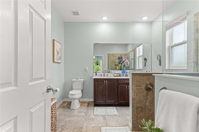 full bath with a walk in shower, vanity, visible vents, toilet, and baseboards