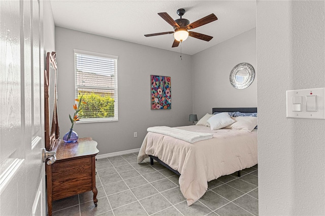 bedroom with tile patterned floors, baseboards, and a ceiling fan