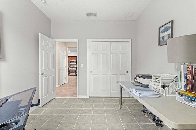 office featuring visible vents and light tile patterned flooring