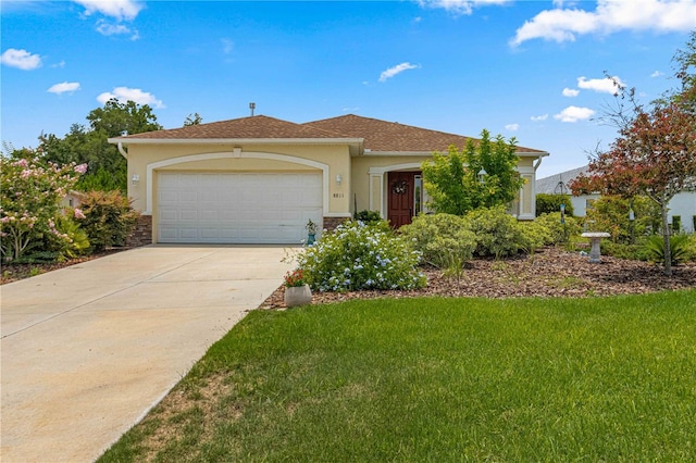 view of front of property featuring a garage, a front yard, stucco siding, and concrete driveway