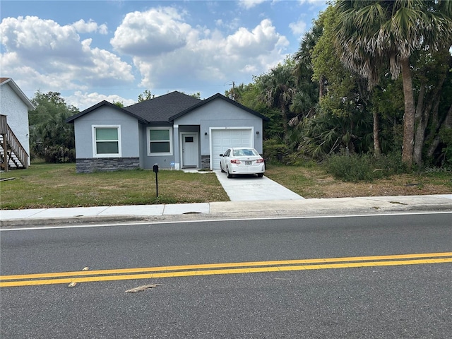 view of front of home with concrete driveway, stucco siding, stone siding, a front lawn, and an attached garage